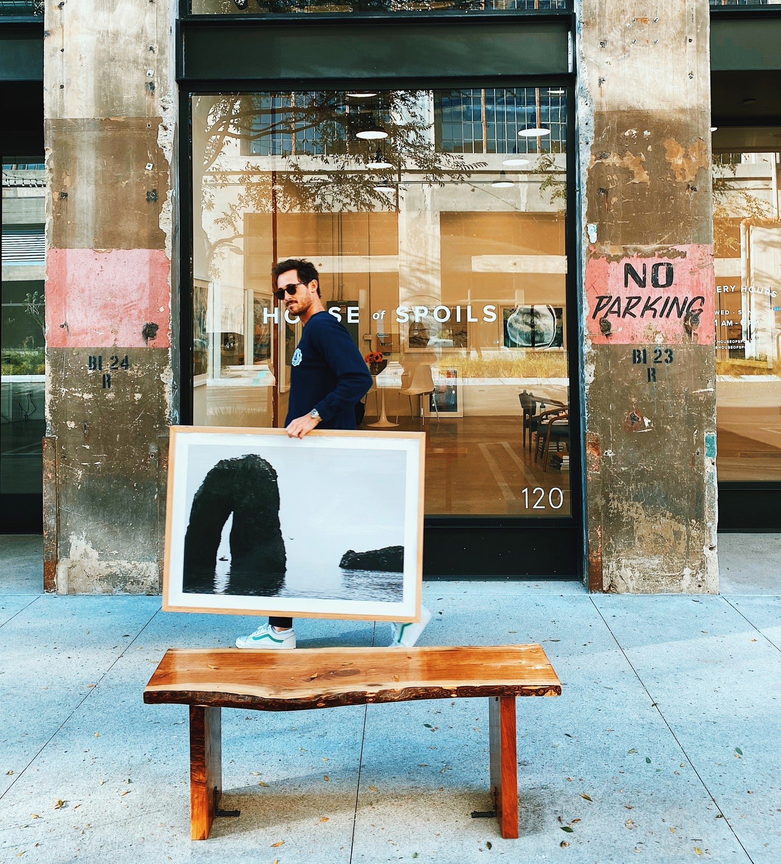DTLA gallery exterior with a person holding a framed photograph — owner-selected exhibition image