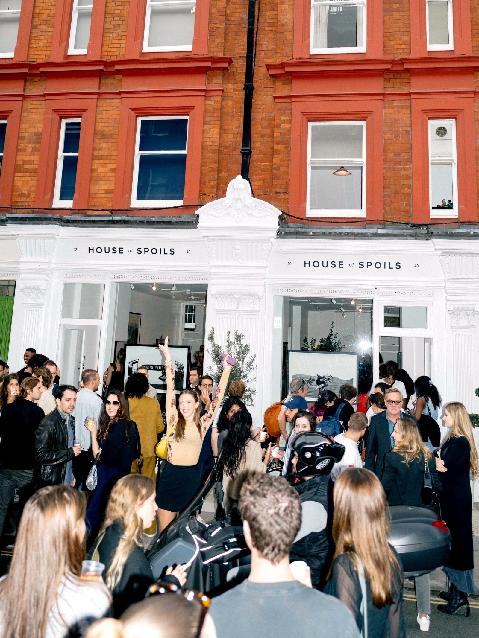London gallery gathering beneath the House of Spoils building signs — owner-selected exhibition image