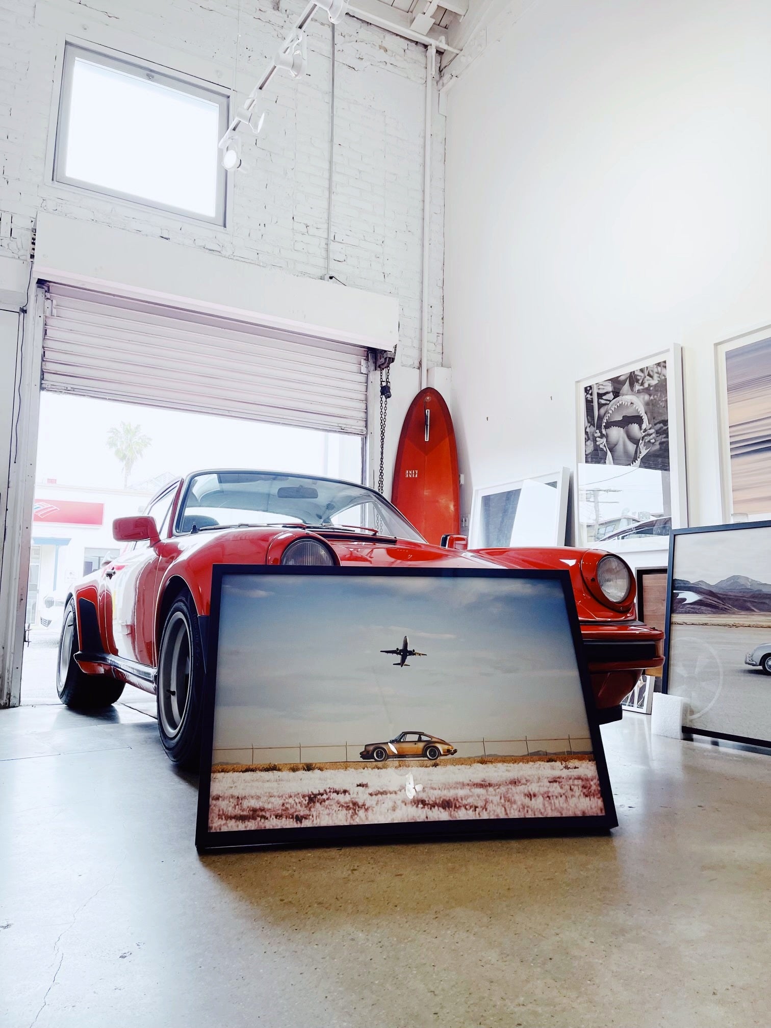 Venice Beach gallery with a red car and framed photographs — owner-selected exhibition image